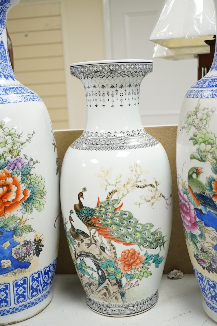 A large pair of Chinese polychrome vases, 60cm high, a pair of famille rose vases, a blue and white brushpot and two other vases (7).